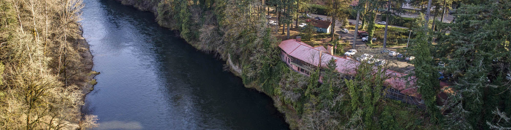 campus overlooking a river in wooded area