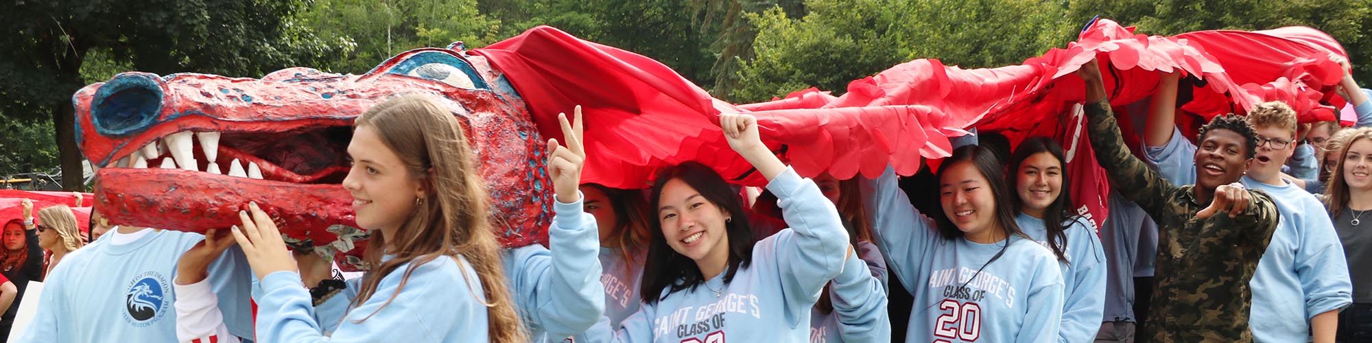 students holding up dragon