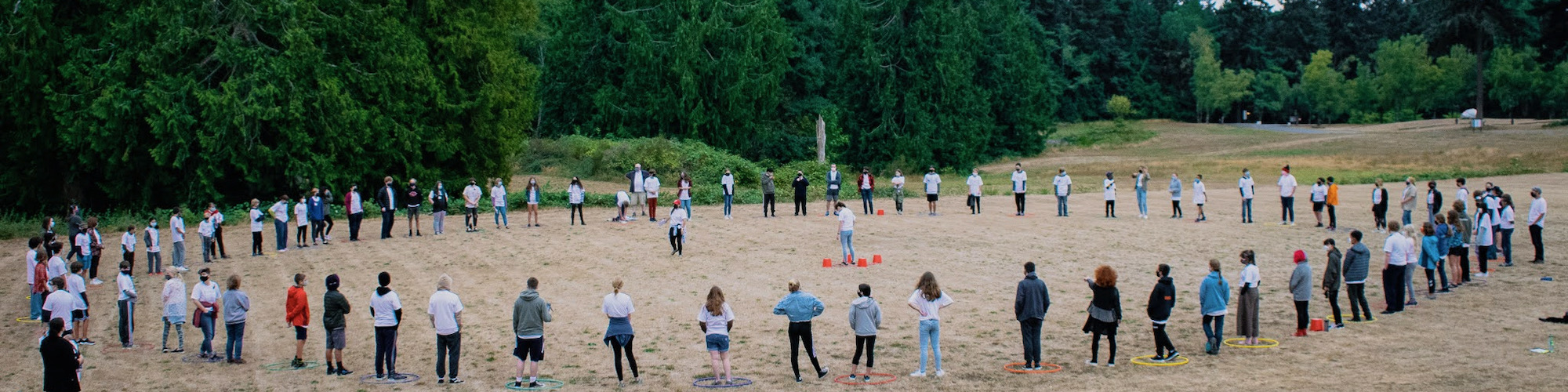 many students forming a ring around a field