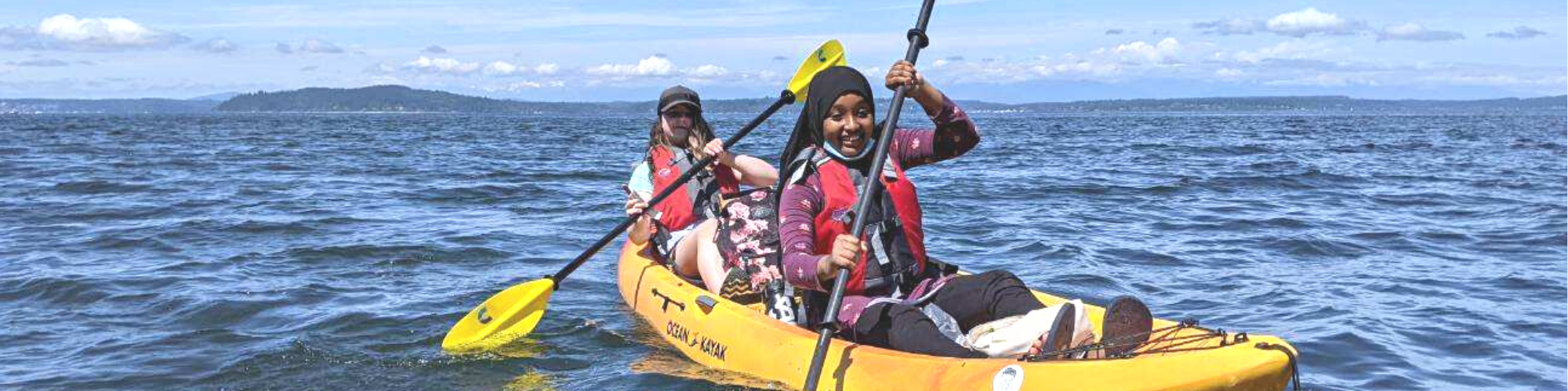 two girls rowing a kayak