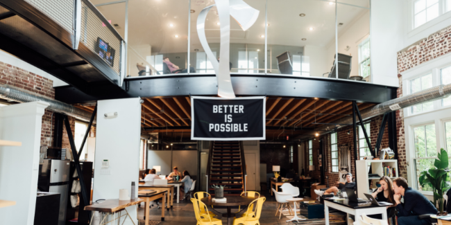 Office photo with sign reading 'Better is possible'