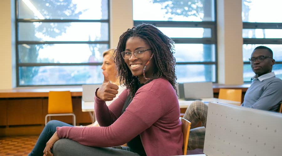 Black female student giving thumbs up