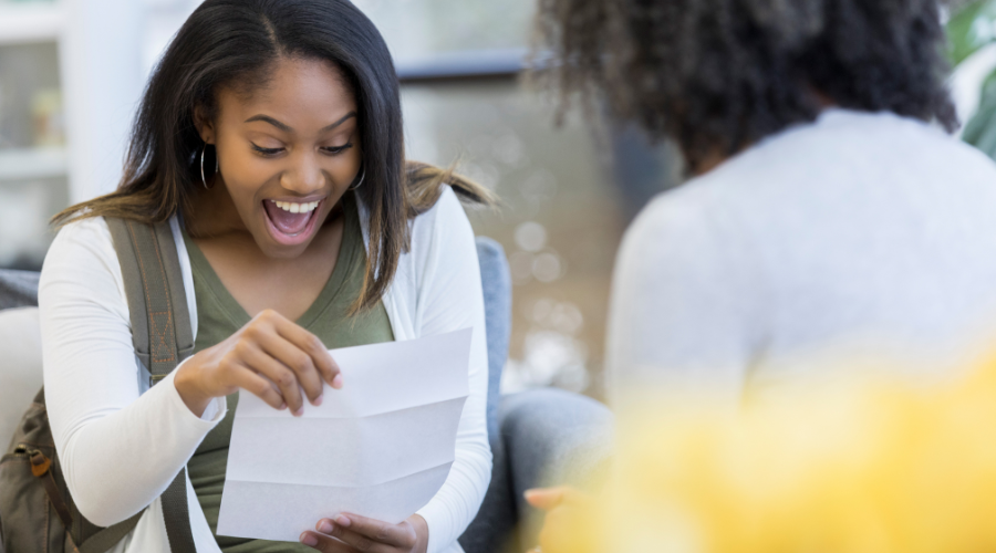 Smiling student opening offer letter
