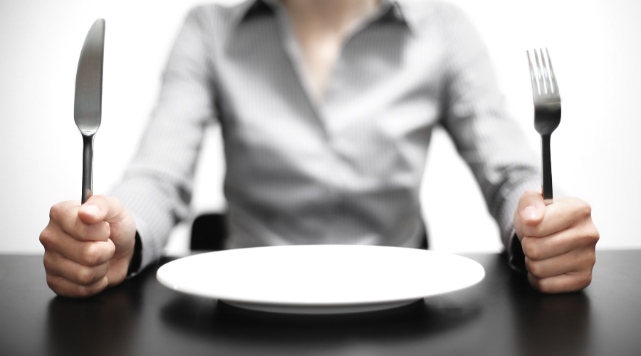 Hungry person sitting at table