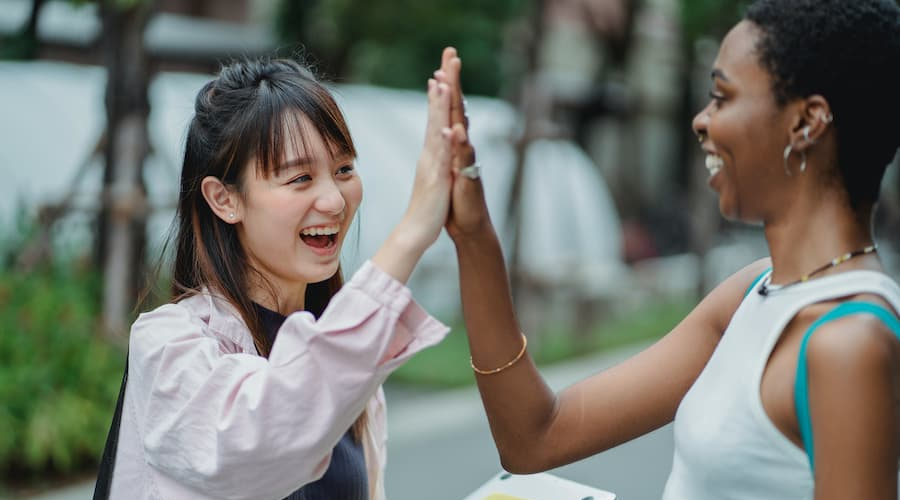 Two people high fiving
