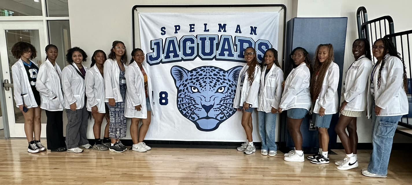 Group of students in front of Spelman Jaguars sign
