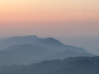 Landscape view of misty mountains receding into the distance