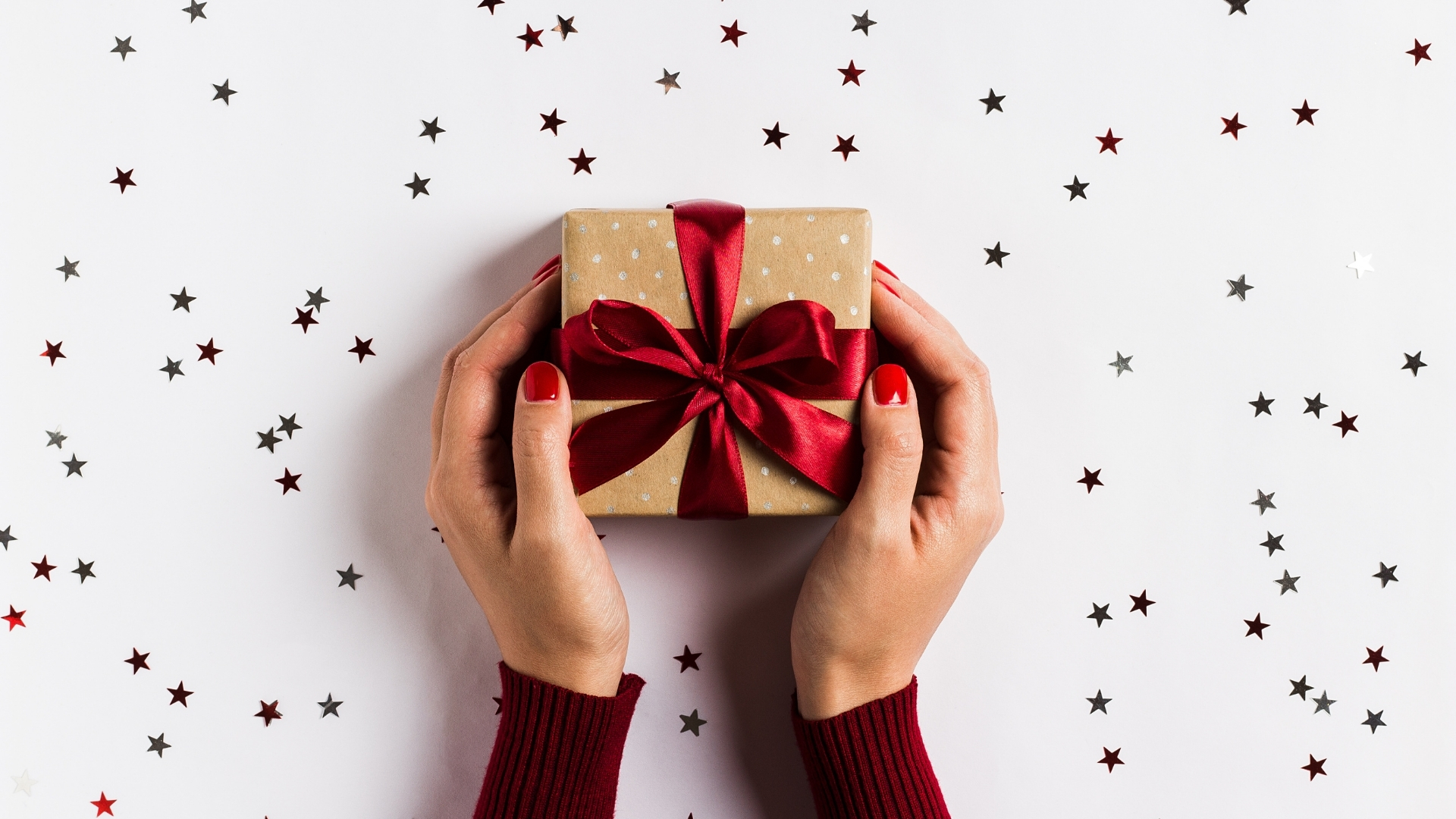 Handing a Gift Across a Table covered in glitter