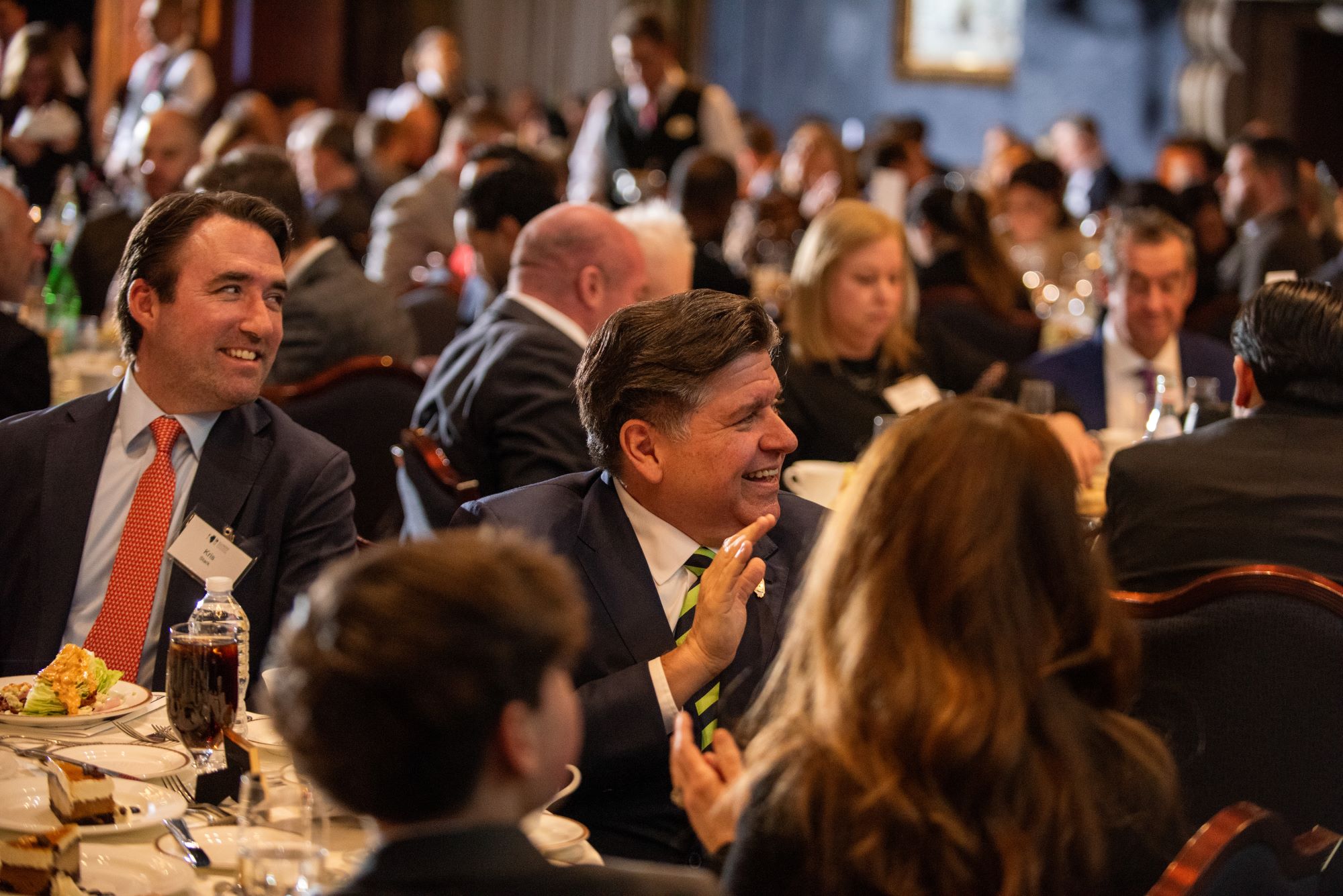 Governor JB Pritzker seated at a table