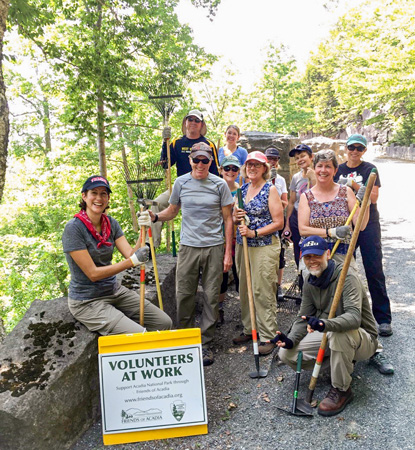 Group of faculty and students helping clean a trail at a National Park.