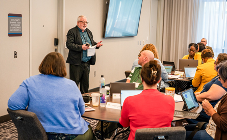 New Directors Institute participants listening to a presentation.