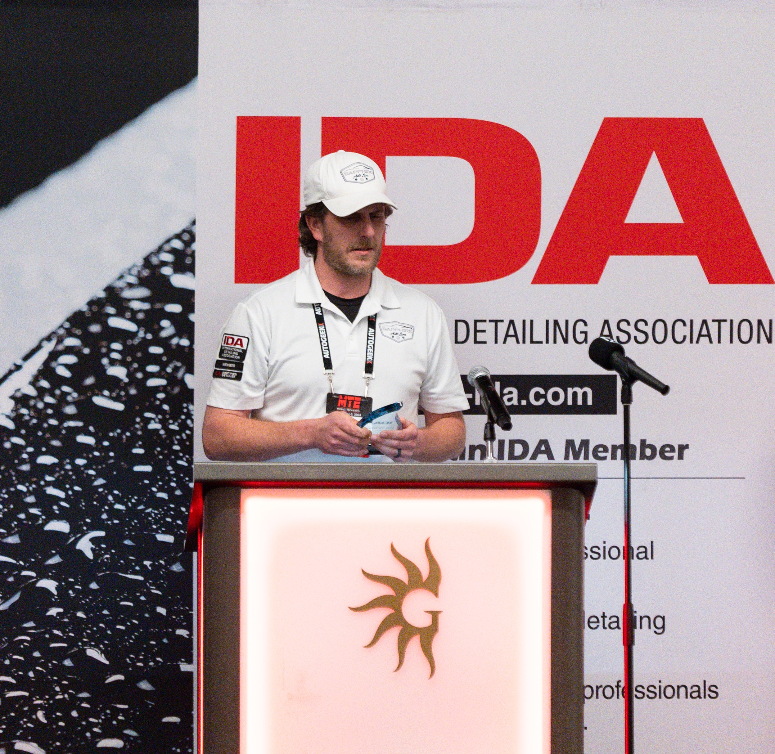 Photo of Dan Belair standing at the podium