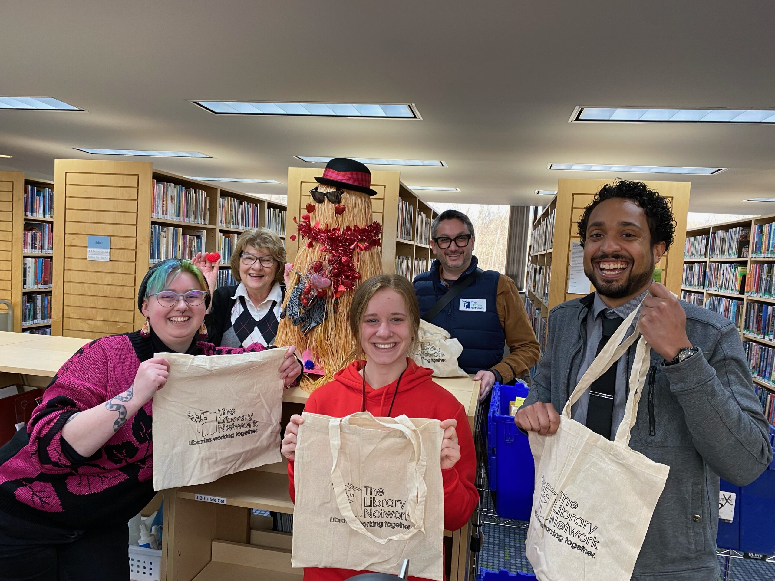 Manchester District Library and The Library Staff holding bags