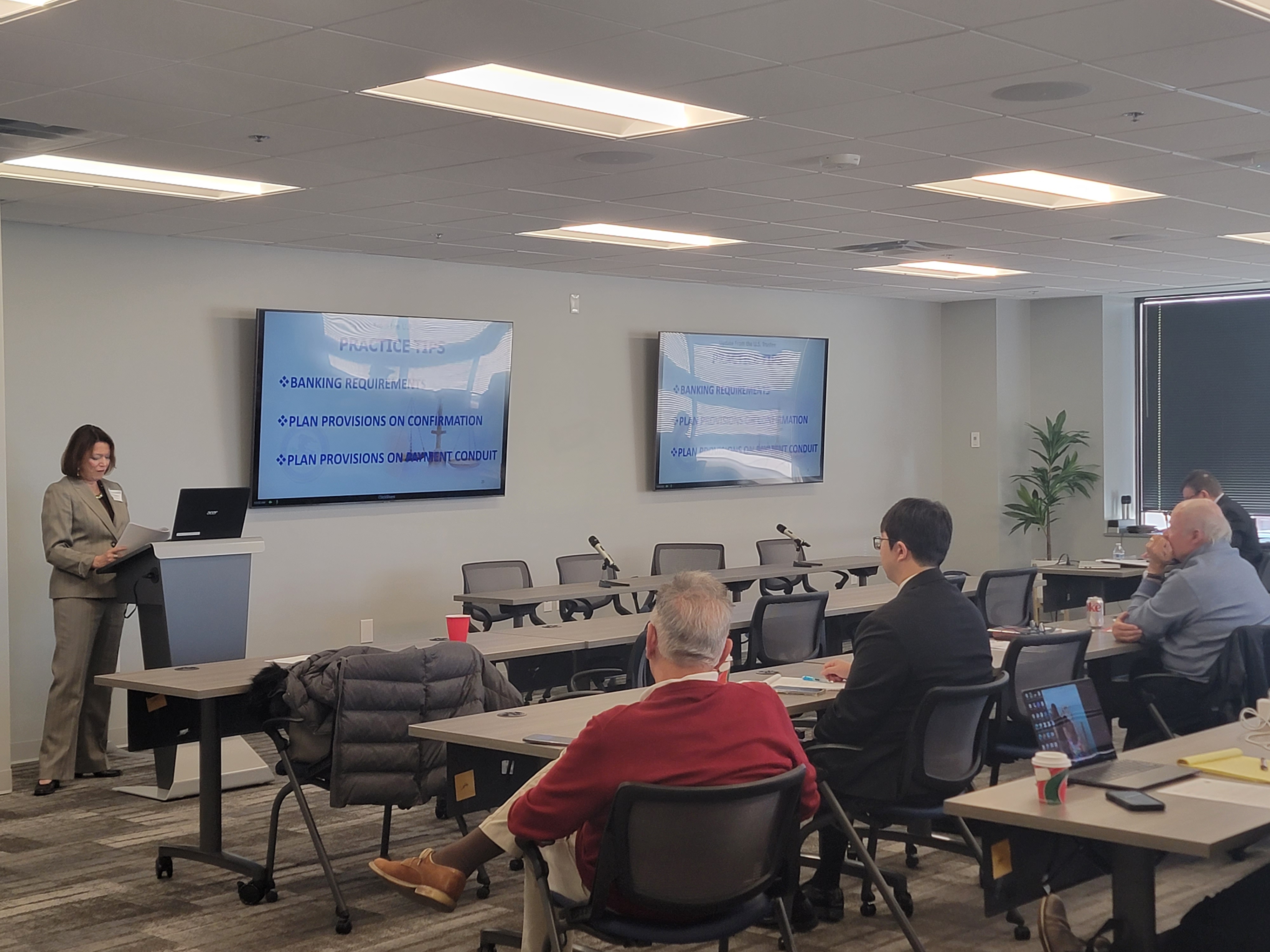 A small group watching a bankruptcy presentation