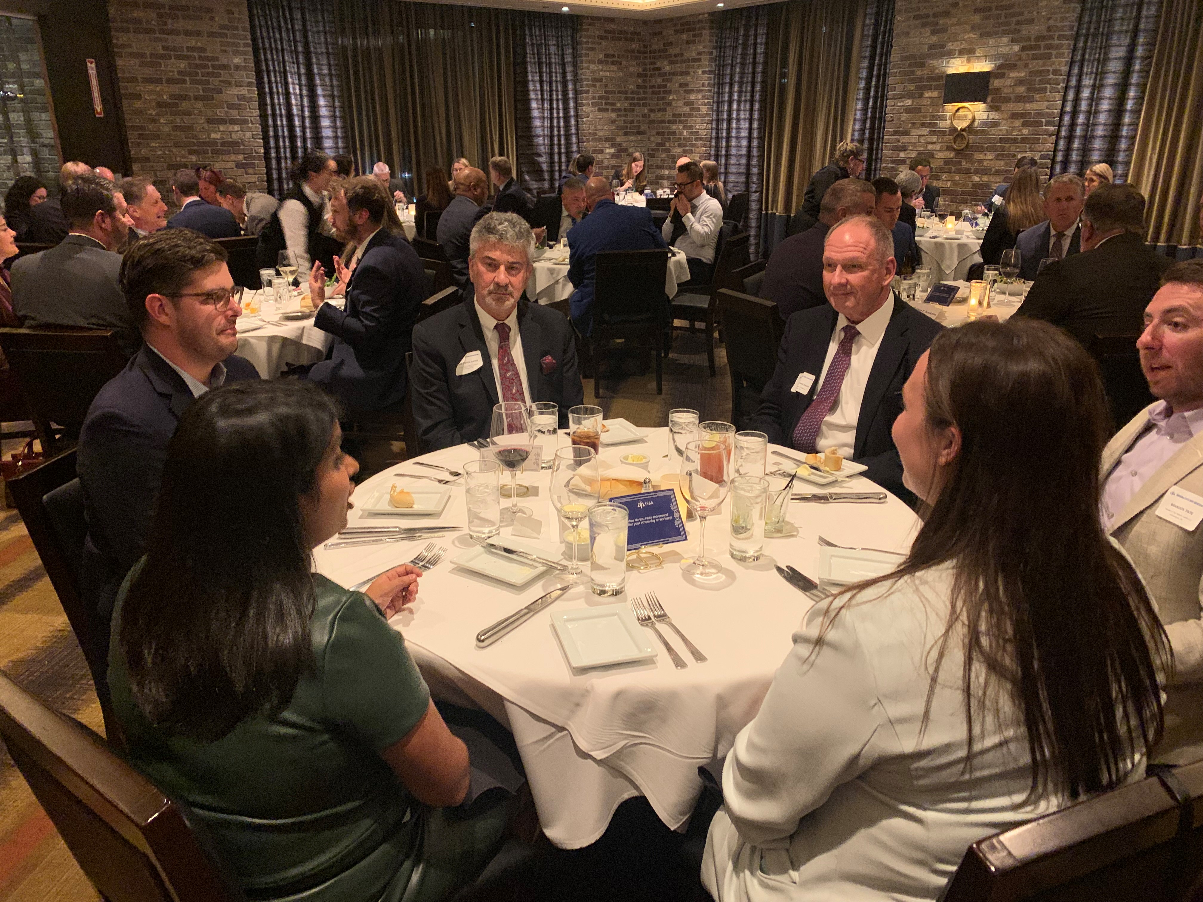 A group of lawyers and judges sitting around a dining table