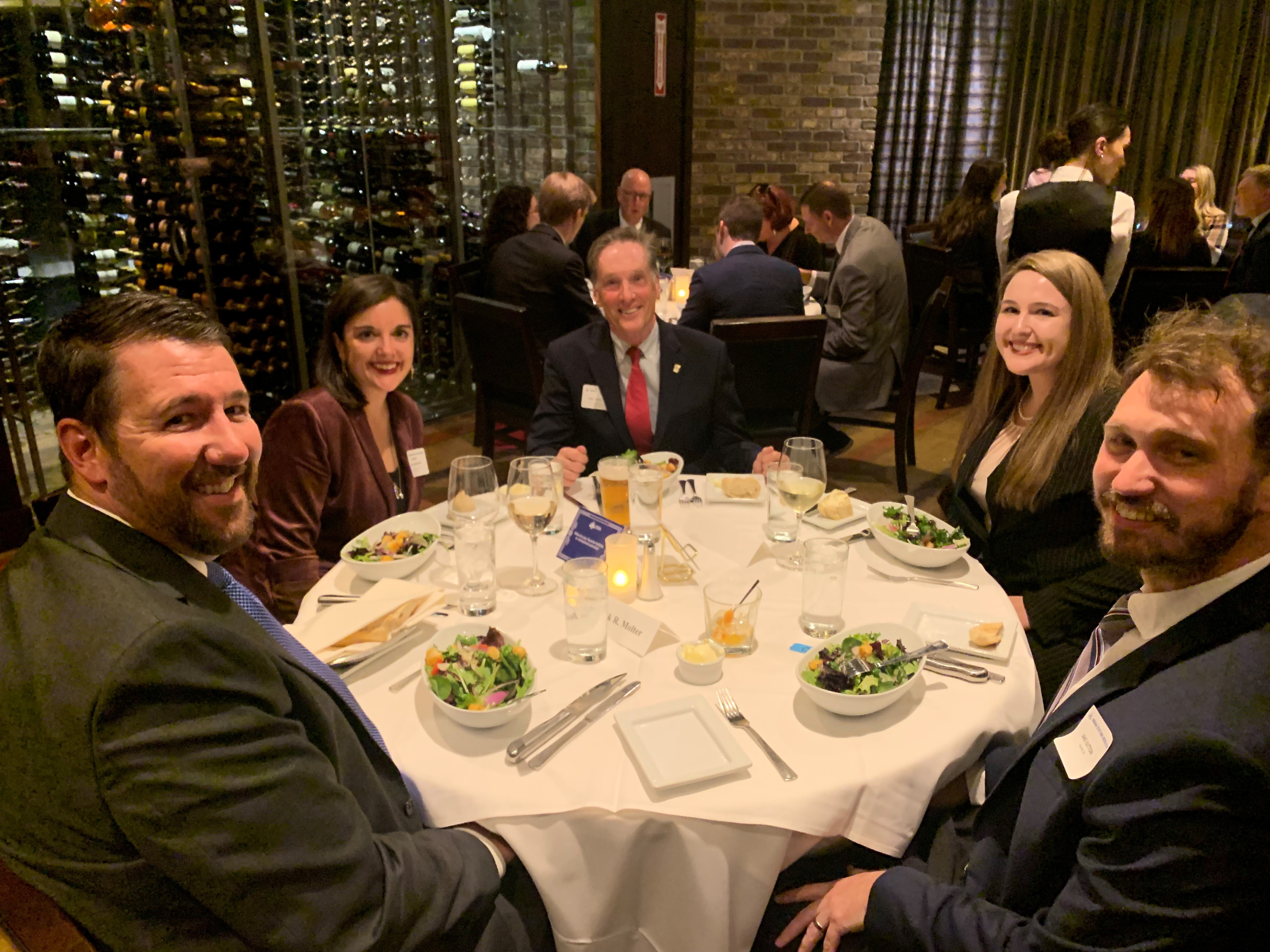A group of lawyers and judges sitting around a dining table