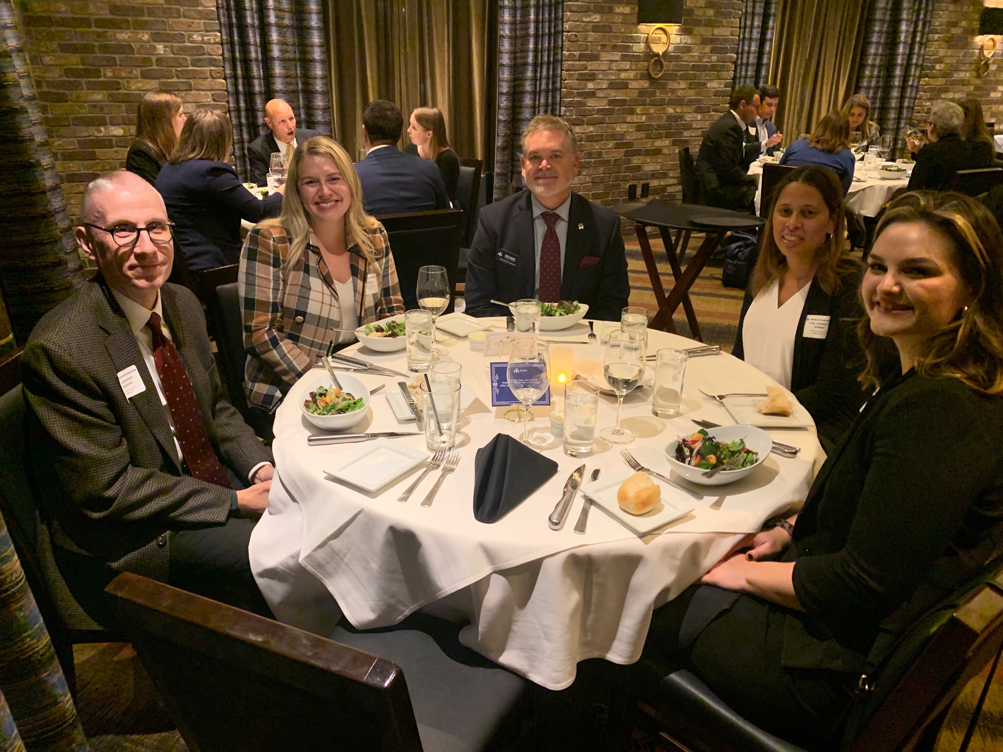 A group of lawyers and judges sitting around a dining table