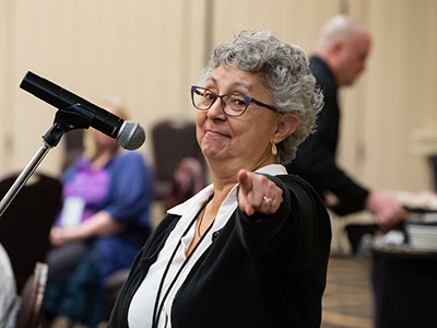 NP attendee pointing at camera